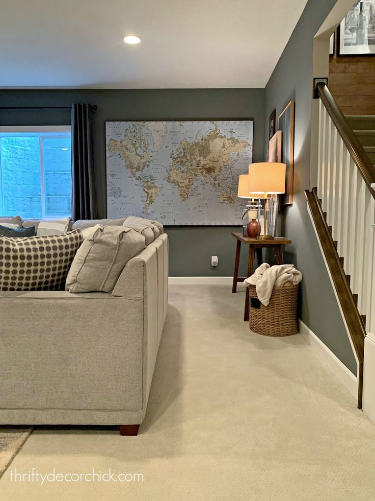 a living room filled with furniture and a map on the wall in front of it