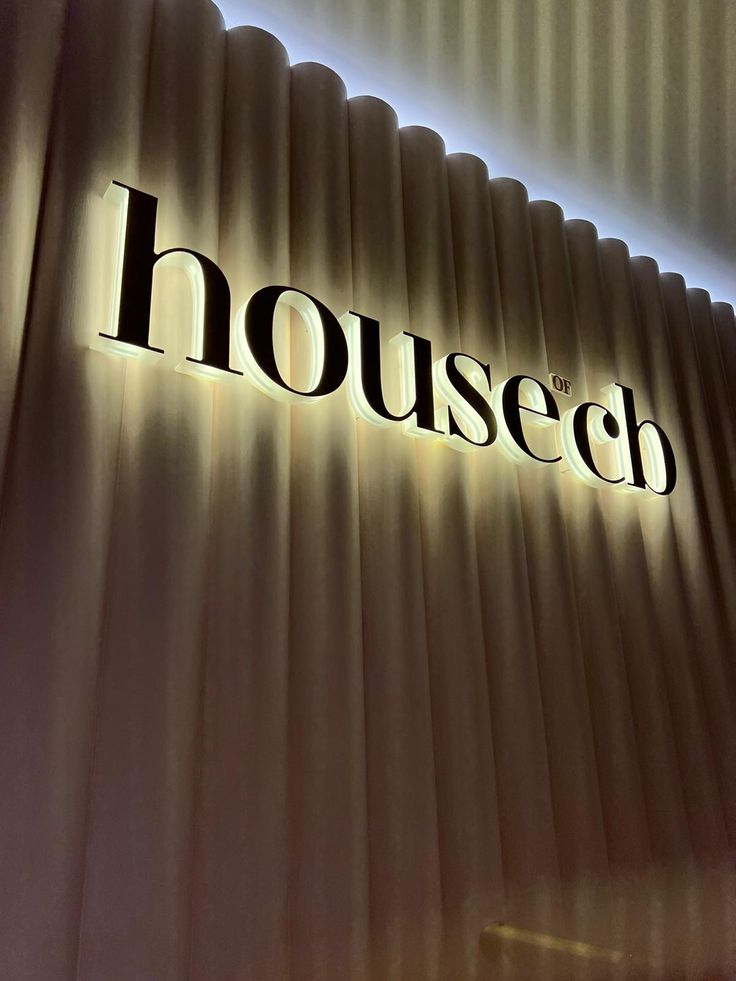 the housech logo is lit up on a wall