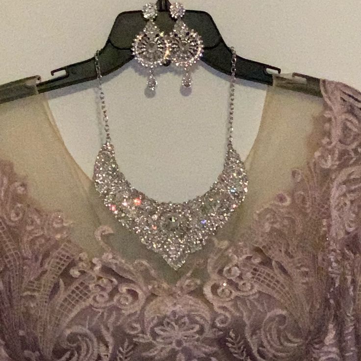 a woman's dress is displayed on a mannequin with jewelry hanging from it