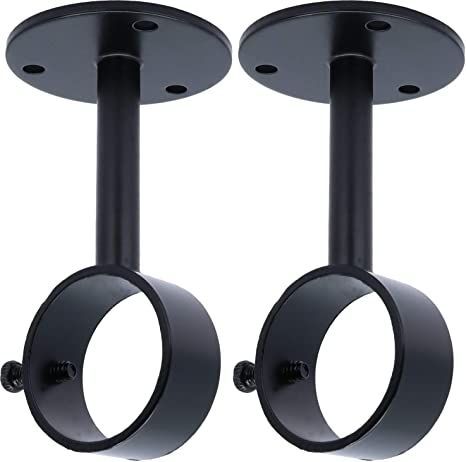 pair of black metal circular candle holders on white background