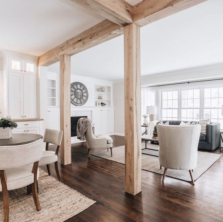 a living room filled with furniture and a clock mounted to the side of a wall