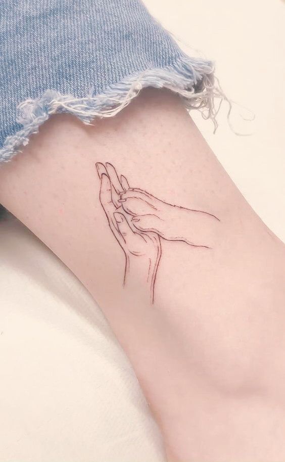 a woman's foot with a small tattoo on the side of her left leg