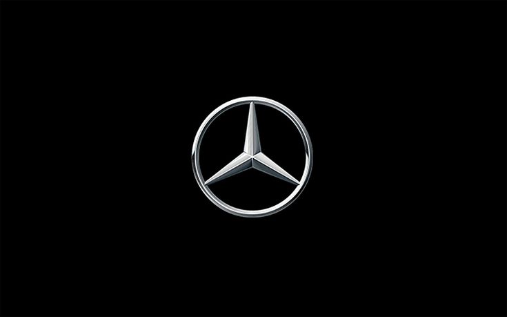 the mercedes logo is shown on a black background in this image, it appears to be an emblem