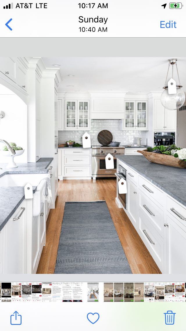 a kitchen with white cabinets and gray counter tops is shown on the app store's home page