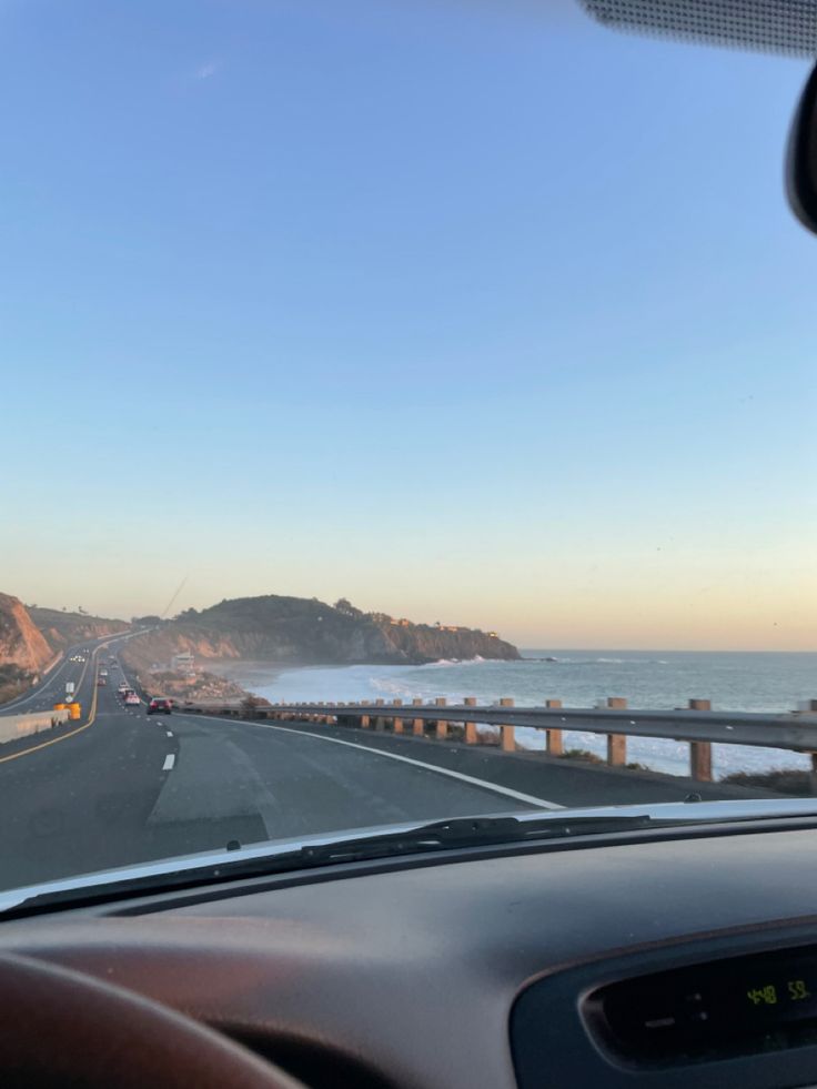 the view from inside a car looking out at the ocean