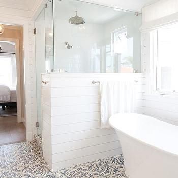 a white bath tub sitting inside of a bathroom