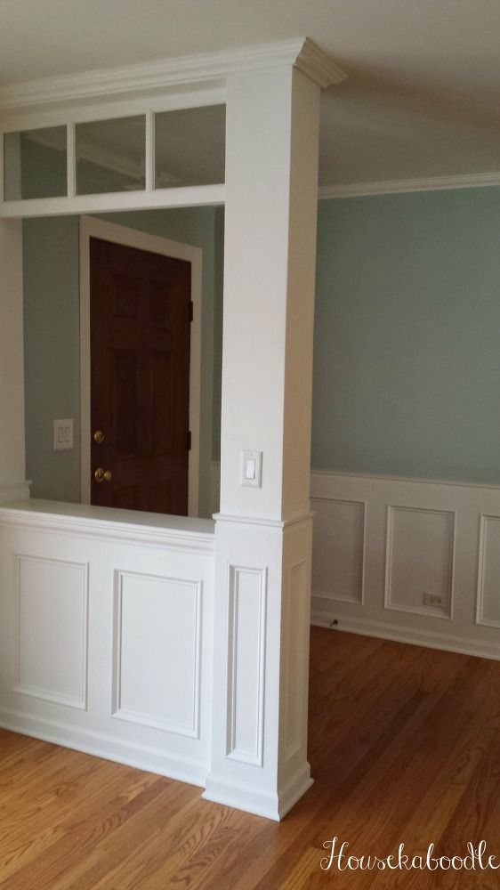 an empty living room with hard wood floors and built in shelving units on the wall