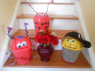 three vases with flowers in them sitting on the stairs