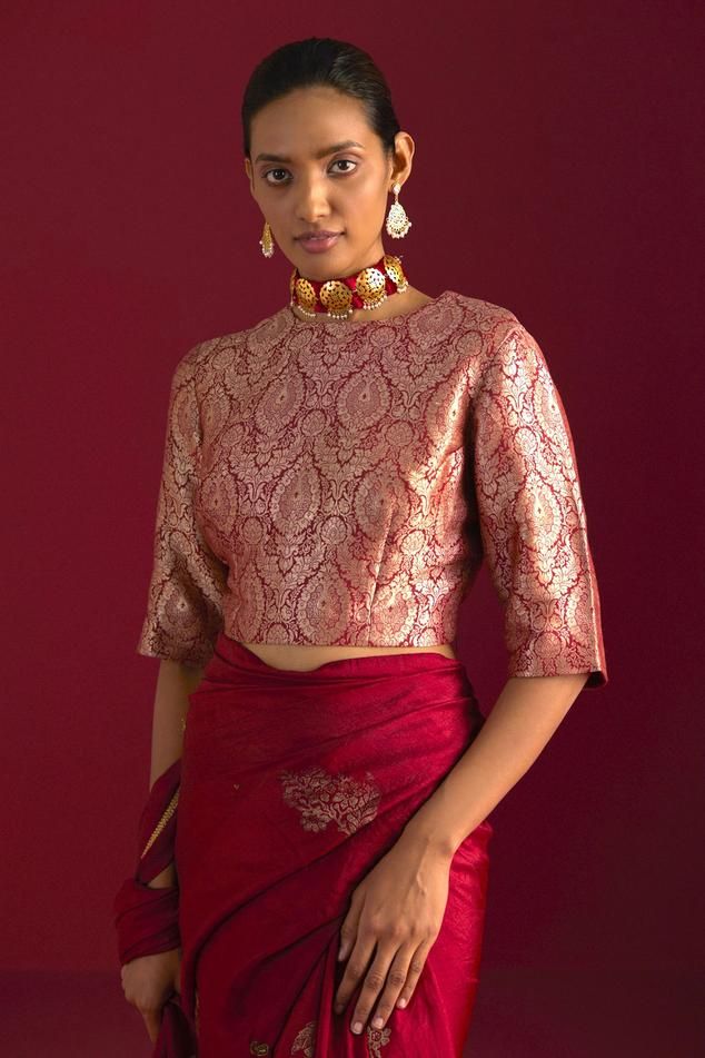 Red Mughal brocade zero neck blouse with floral patterns.
Components: 1
Type Of Work: Floral
Neckline: Zero Neck
Sleeve Type: Three Quarter
Fabric: Brocade, Lining: Shantoon
Color: Red
Other Details: 
Length: 16 inches
Model height: 5ft 9inches, wearing size M
Note: Saree worn by the model is not for sale
Disclaimer: Since all our products are sustainable, touched by human hands be it weaving, block printing, or embroidery, there might be slight imperfections that make them unique and individual Banarasi Brocade, Brocade Blouses, Human Hands, Fancy Blouses, Pattern Blouse, Fancy Blouse Designs, Blouse For Women, Block Printing, V Neck Blouse