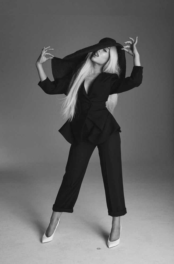 a woman with long blonde hair posing in black and white