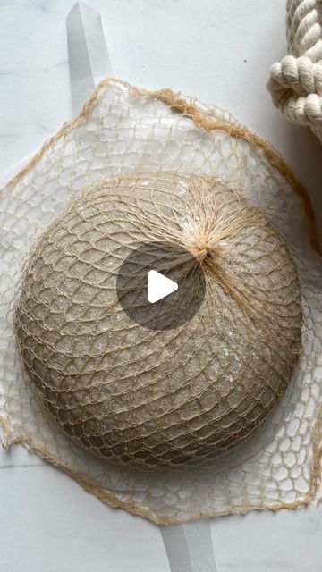 a piece of jute sitting on top of a white table next to an object