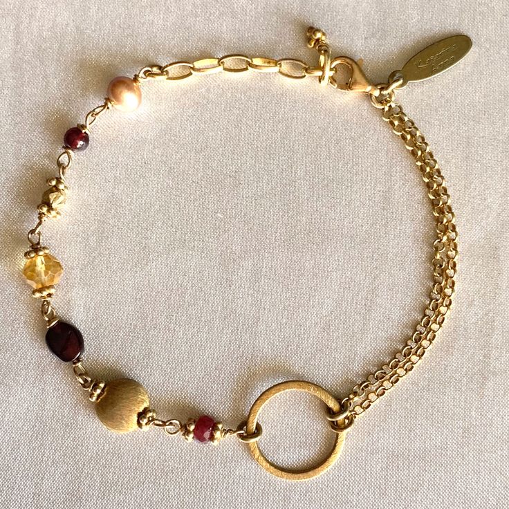 "This contemporary 14k Gold plated Sterling silver and Gemstone bracelet can be your everyday favorite to wear casually, or for a night out. A mix of Ruby, Citrine, Garnet and Freshwater Pearl integrates to a satin finished circle and Rolo link chains. The overall length is adjustable 7\"- 8\".  Ships in a small gift box. To learn more about my jewelry, please visit the links:  www.katarina-anna-design.com @katarina.anna.design" Elegant Gold Bracelet With Natural Stones, Elegant Everyday Jewelry With Unique Variations, Elegant Metal Bracelets With Natural Stones, Modern Gold Bracelets With Natural Stones, Elegant Gold Chain Bracelet With Natural Stones, Modern Round Bracelets With Adjustable Chain, Elegant Metal Beaded Bracelets With Natural Stones, Elegant Full Circle Handmade Jewelry, Modern Bracelets With Natural Stones