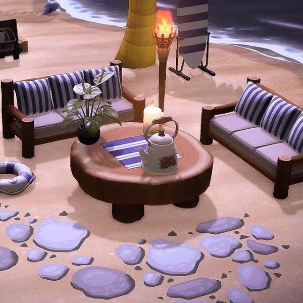 a living room filled with furniture on top of a sandy beach