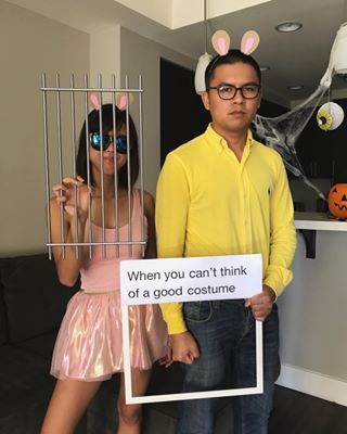 a man and woman dressed up as bunny ears holding a sign that says, when you can't think of a good costume