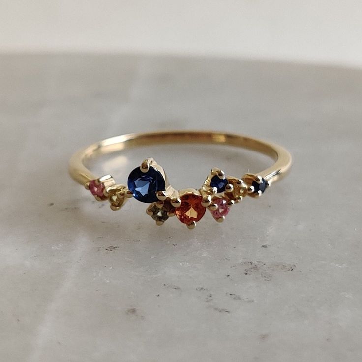 ITEM DESCRIPTION: >>The ring is made from Solid 14K Yellow Gold.  >>Gemstone used is absolutely natural and ethically sourced.  >>Natural Multi Sapphire ring in prong setting is studded on it with utmost precision.  Gem: Multi Sapphire Gem size & shape: 3.00 mm and Round (1pcs) Gem size & shape: 2.50 mm and Round (1pcs) Gem size & shape: 1.50 mm and Round (7pcs) Total Gem weight: 0.35 carats Gold purity: 14K (58.33% approx.) Gold weight: 1.30 grams Gross weight of ring: 1.37 grams The Gold purity is guaranteed and it comes with authentic 14K gold hallmark. Since these Rings are handmade, they are Nickel/Lead FREE.  CUSTOMIZATION: >>Size Customization is available for this ring and it is available in all ring sizes. >>Gemstone customization is also available and the main gemstone can be sub Gold Sapphire Multi-stone Ring, Unique Gold Sapphire Ring With Gemstone Accents, Unique Yellow Gold Sapphire Ring With Accent Stones, Fine Jewelry Multi-stone Cluster Ring Gift, Fine Jewelry Cluster Ring With Multi-stones For Gifts, Fine Jewelry Sapphire Cluster Ring As Gift, Gold Cluster Rings With Gemstone Accents, Sapphire Cluster Ring Birthstone Gift, 14k Gold Cluster Ring Gift