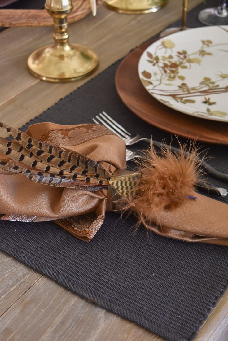 the table is set with plates, silverware and napkins