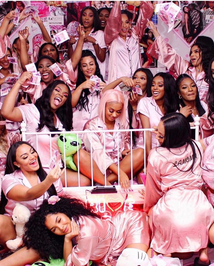 a group of women dressed in pink posing for the camera