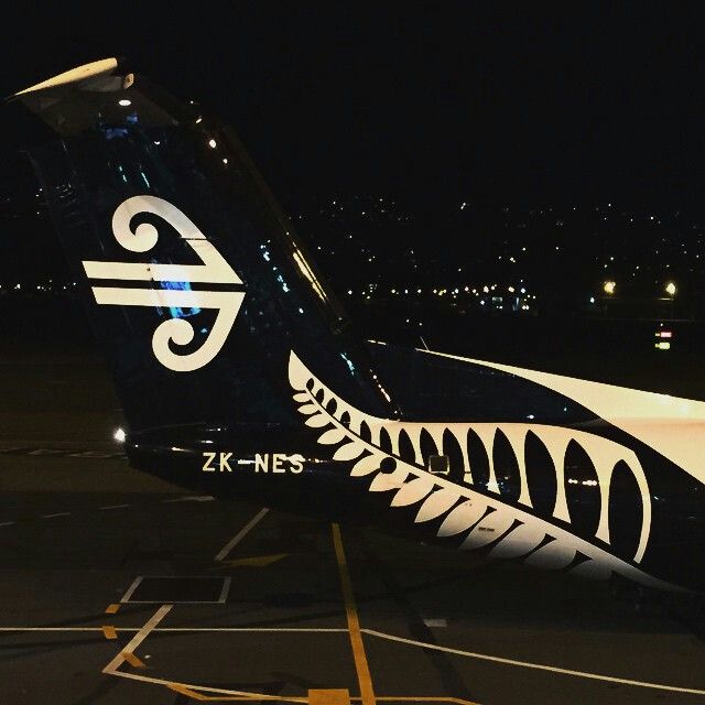 an airplane is parked on the runway at night