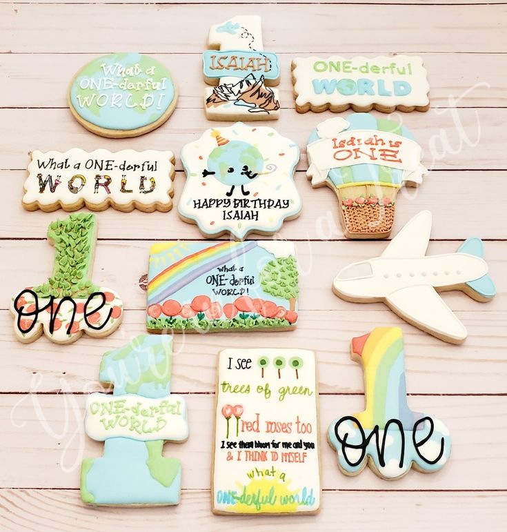 decorated cookies are arranged on a table with words and pictures in the shape of animals