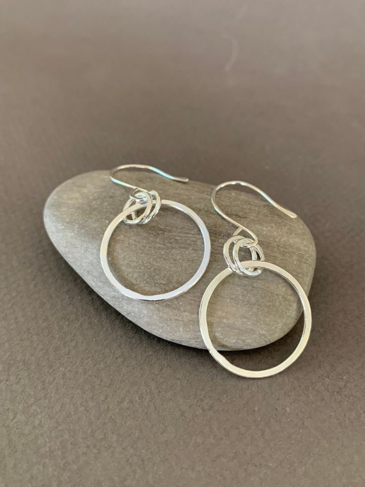 "Hand Forged Metal Jewelry | Silver Hoop Earrings, Fine Sterling Silver These round hoop earrings are perfect for everyday wear and would make a wonderful gift. We use only fine and sterling silver for all of our jewelry and findings, including our handmade earwires. Shaped and hammered for simplicity and elegance; then tumbled for strength and durability. Size is approximately 7/8\" x 1 7/8\". Our designs are each individually handcrafted and made to order.. because of this each design may have Silver Single Open Circle Earring, Single Silver Open Circle Earring, Simple Small Hoop Nickel-free Jewelry, Simple Nickel Free Small Hoop Jewelry, Simple Nickel-free Small Hoop Earrings, Simple Nickel-free Small Hoop Jewelry, Modern Round Wrap Earrings As Gift, Sterling Silver Hoop Jewelry Gift, Sterling Silver Hoop Jewelry As Gift