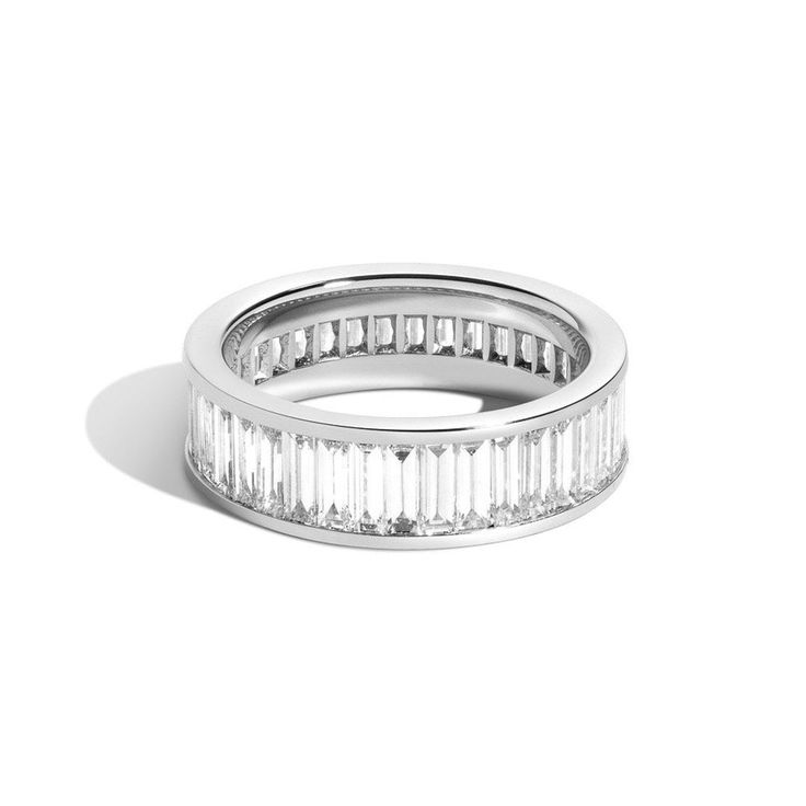 The Landmark Series celebrates love in NYC. Inspired by the structural boldness of iconic New York architecture, the collection captures the essence of Gotham. This diamond baguette eternity band was designed to represent the footprint and buildings of the iconic Rockefeller Center. Each piece empowers the wearer to reveal romance by making their very own love landmark. Baguettes are vertically channel set 360 degrees. Modern Rings With Baguette Diamonds, Modern White Gold Eternity Band For Formal Occasions, Modern Baguette Cut Rings For Everyday Luxury, Luxury Halo Baguette Cut Rings, Modern Diamond Baguette Cut Rings, Modern Jewelry With Baguette Diamonds For Everyday Luxury, Modern Baguette Diamond Cut Jewelry, Luxury Baguette Ring For Formal Occasions, Luxury White Gold Eternity Band With Baguette Cut