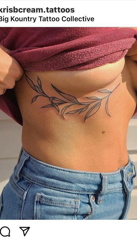 a woman's stomach with an olive branch tattoo on it