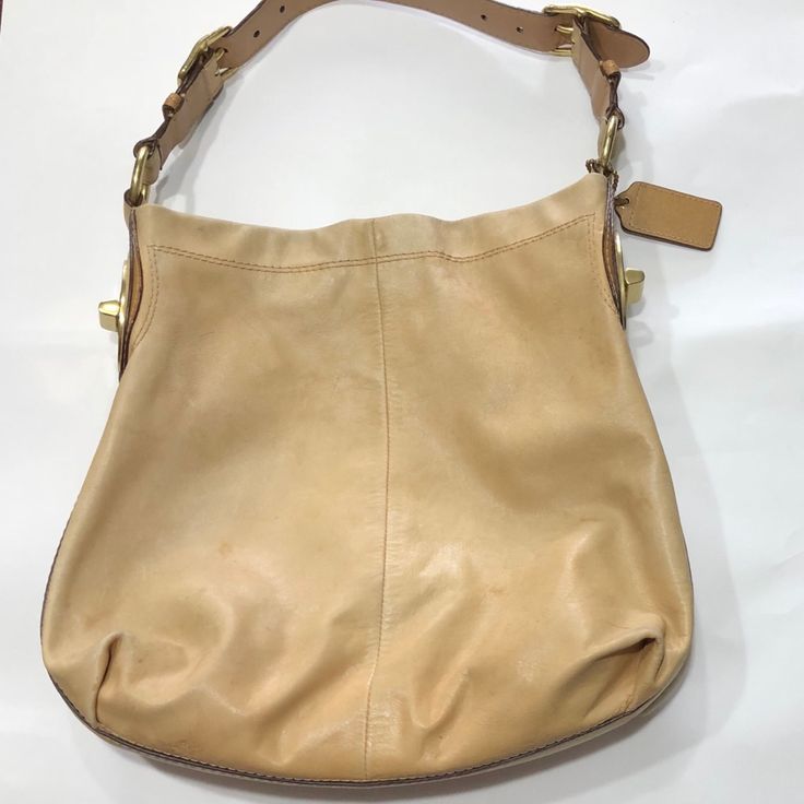 Preowned Coach Peyton Leather Shoulder Bag In Caramel Color. Beautiful Buckles. Magnetic Snap Closure. Belt Strap That Is Adjustable To 3 Hole Position On Each Side Of Strap. Coach Leather Hangtag. Inside Lined With Poppy Polka Dot Lining- Cutie. Back Interior Zippered Compartment With Coach Creed And Two Front Wall Interior Slip Pockets. See Pictures For Condition. Some Noticeable Wear, But Still A Very Beautiful Purse. Elegant Light Brown Hobo Bag For Shopping, Gold Leather Hobo Bag With Leather Handles, Elegant Caramel Soft Leather Shoulder Bag, Chic Light Brown Leather Bucket Bag, Designer Coach Hobo Bag For Everyday, Chic Camel Hobo Bag In Soft Leather, Chic Caramel Leather Shoulder Bag, Camel Leather Bag For Errands, Designer Beige Hobo Bag For Everyday