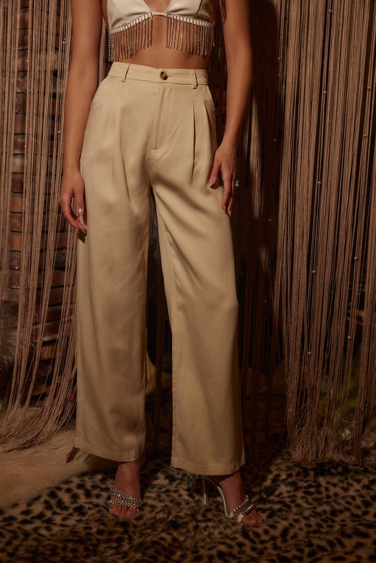 Your spring fit just got that much better thanks to the Jaxon Cream Trousers. Wear from work to happy hour, these pants are easily dressed up or down. Style with your favorite crop, our Isla Straw Fedora, a pair of strappy sandals, and you're set for the entire day! PRODUCT DESCRIPTION AND MATERIALS: - cream wide leg trousers - pleated - button closure - functional front pockets - non-functional welt back pockets - high waisted fit - finished hem - 100% lyocell - dry clean only SIZE RECOMMENDATI Wide Leg Pants For Spring Date Night, Wide Leg Pants For Date Night In Spring, Chic Tapered Leg Pants For Date Night, Spring Bottoms With Pockets For Date Night, Spring Date Night Bottoms With Pockets, Spring Date Night High Waist Wide Leg Pants, Chic Tapered Leg Spring Pants, Chic Tapered Leg Pants For Spring, Spring Wide Leg Pants For Business Casual