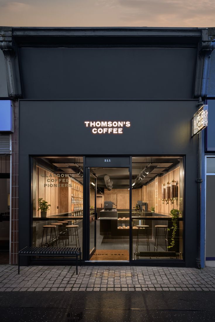 the front entrance of a coffee shop at dusk