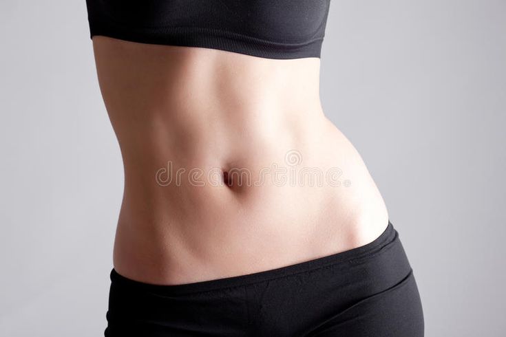 an image of a woman's stomach showing her toned absorption stock photos