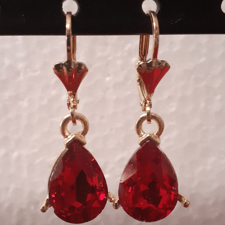 Small red oval crystals dangling on your ear as you go, this design is meant for the person that wants to go all out with a red dress. The pair hangs proportionately and bring more to emphasis to the face. Details Laminated gold Red oval crystal small design Red Jeweled Crystal Drop Earrings, Red Drop Jewelry With Matching Earrings, Red Jeweled Earrings For Evening, Red Crystal Metal Earrings For Parties, Red Jeweled Dangle Earrings, Red Jeweled Drop Earrings, Red Crystal Metal Party Earrings, Red Metal Crystal Party Earrings, Red Jeweled Jewelry For Evening