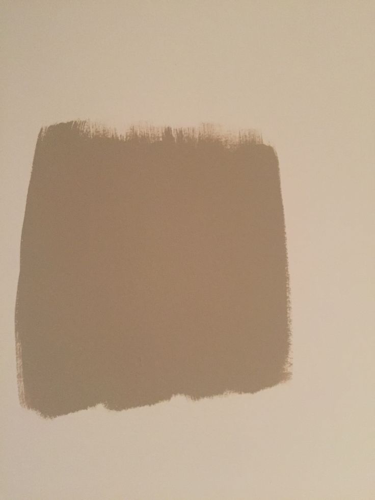 a white wall with a brown stain on the top and bottom part of it's paint swatches