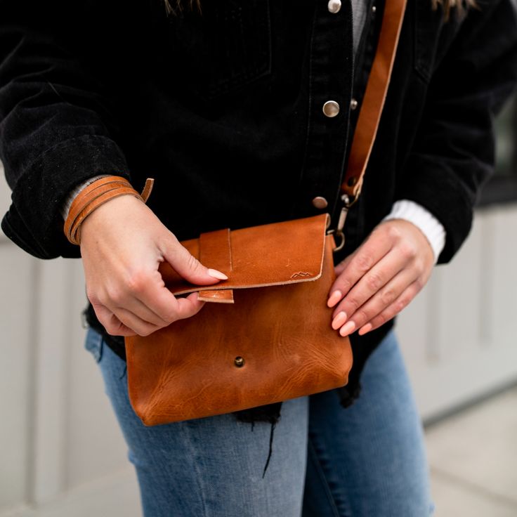 This minimal, full grain leather cross body bag is perfect for the essentials. Outfitted with a fully adjustable cross body strap, this bag will easily accommodate a minimalist wallet, phone, sunglasses and a few other small items. Take what you need without the bother of a big bag on your next outing. The strap is also removable to convert the purse into a small clutch. American Flag Hat, Take What You Need, Crossbody Bags For Travel, Small Clutch, Wrist Wear, Dopp Kit, Minimalist Wallet, Big Bags, Small Crossbody Bag