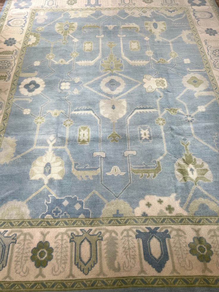 a blue rug with many different designs on it