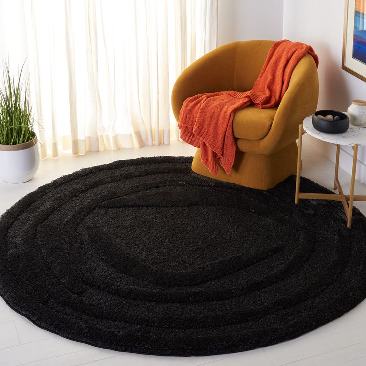 a living room with a chair and rug on the floor