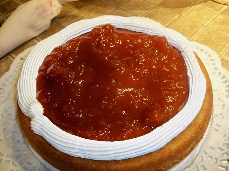 a cake covered in sauce sitting on top of a table