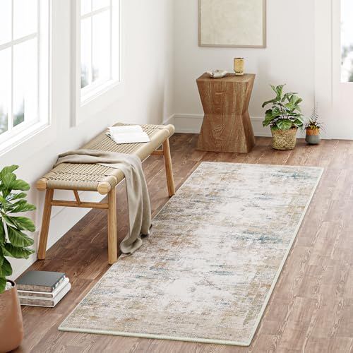 a living room with wooden floors, white walls and a rug on the floor in front of a window