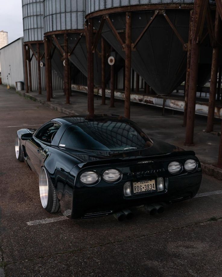 a black sports car parked in front of a building