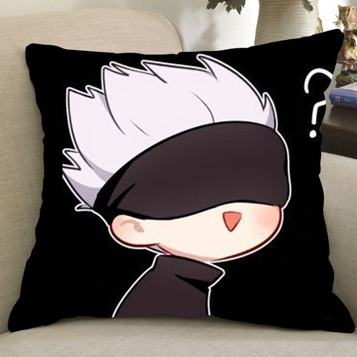 a black and white pillow sitting on top of a couch