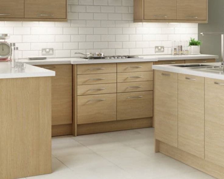 a kitchen with wooden cabinets and white counter tops