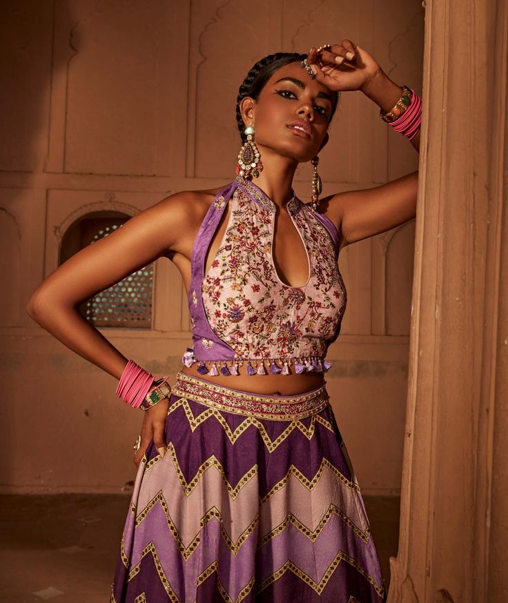 Make a style statement like a traditional diva in this alluring sharara set featuring geometrical print sharara coordinated with an intricately embroidered blouse with a stylised back design with heavy tassels and doris. Bohemian Sharara With Cutdana For Reception, Bohemian Sharara With Traditional Drape For Reception, Bohemian Sharara For Reception With Traditional Drape, Unstitched Blouse Sharara For Navratri, Navratri Purple Palazzo Set With Cutdana, Bohemian Georgette Sharara For Reception, Bohemian Palazzo Set For Reception With Traditional Drape, Unstitched Bohemian Lehenga, Semi-stitched Sharara With Motifs