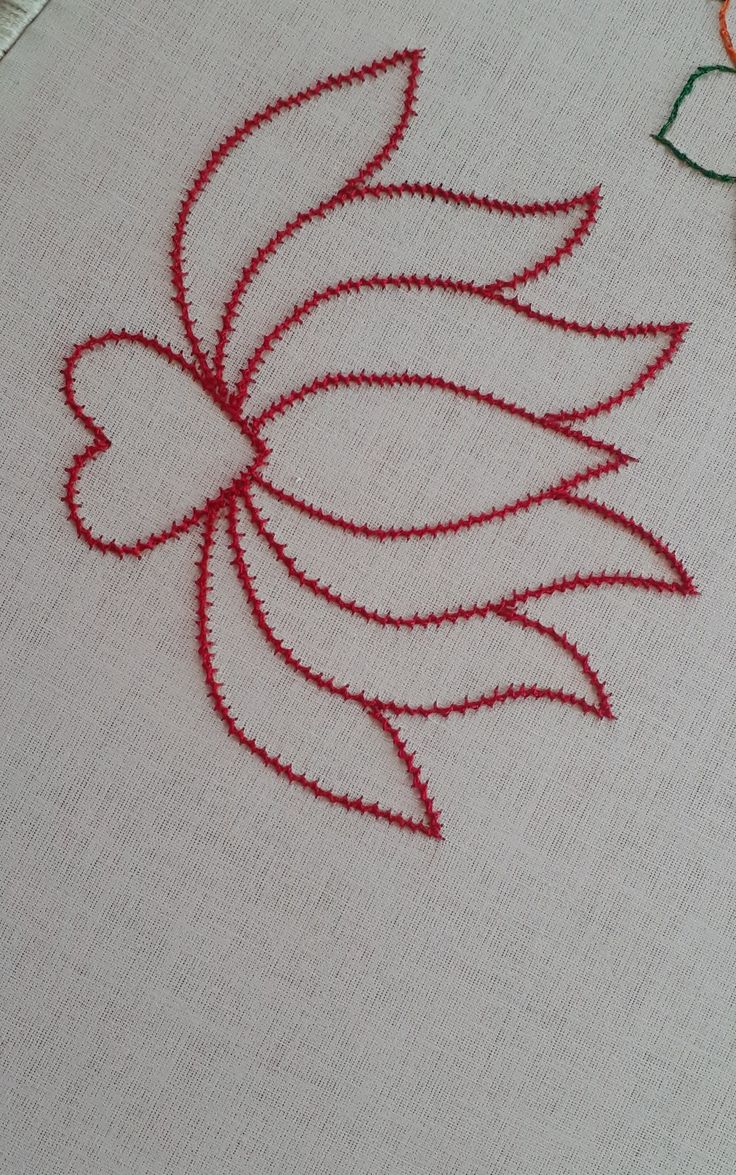 a close up of a piece of cloth with red thread