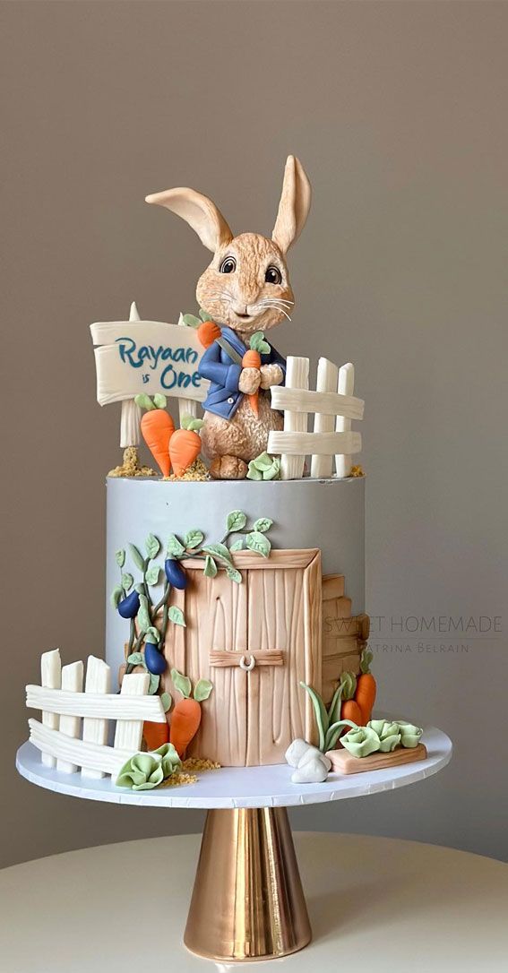 there is a cake that looks like a rabbit on top of the house with carrots