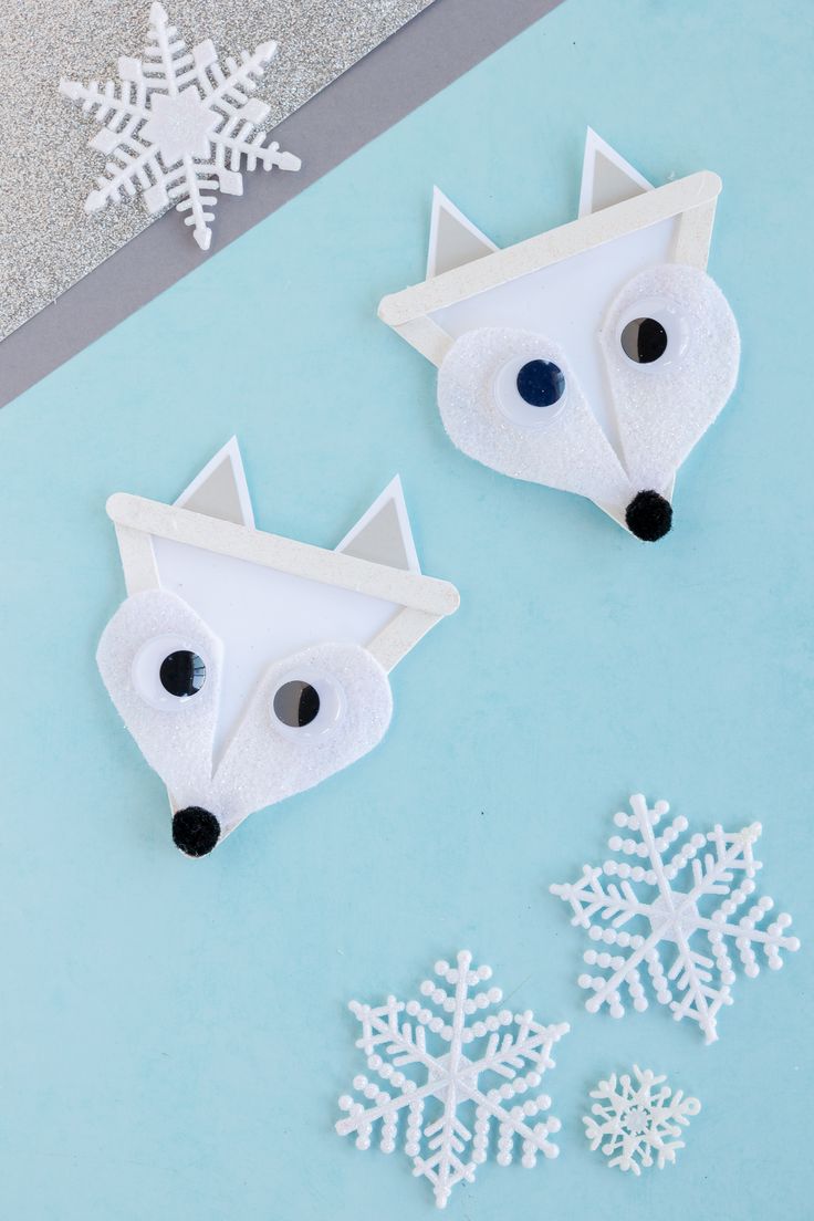 paper mache fox and snowflakes on a blue background