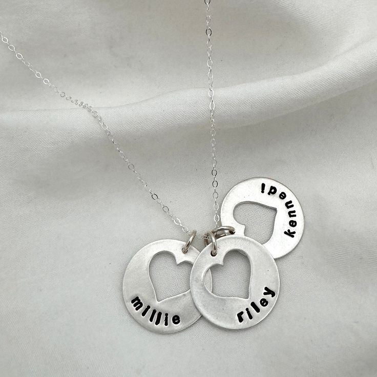 Keep your sweethearts close to you with one of our most beloved designs. Each heart cutout charm can be personalized with up to 8 characters. Add birthstones to make it a truly unique and special keepsake to be treasured forever. ~ Make it uniquely yours by visiting our Charm and Stone categories ~ Our personalized jewelry is made by hand. Please allow 1 to 2 weeks for your order to ship from our studio. Customizable Heart Pendant Name Necklace For Gift, Customizable Heart Pendant Name Necklace Gift, Customizable Heart-shaped Name Necklace For Gift, Customizable Heart Pendant Necklace For Personalized Gift, Nickel-free Double Heart Jewelry For Valentine's Day, Heart Pendant Charm Necklace For Birthday And Mother's Day, Nickel-free Round Heart Necklace For Valentine's Day, Valentine's Day Nickel Free Heart Necklace, Nickel Free Heart Cut Jewelry For Valentine's Day