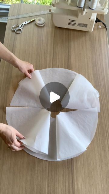 someone is making a cake with white paper