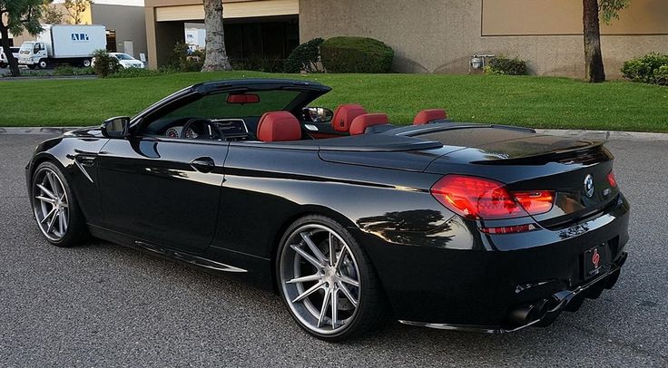 a black convertible car parked in front of a building