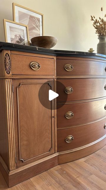 a wooden dresser with pictures on top of it