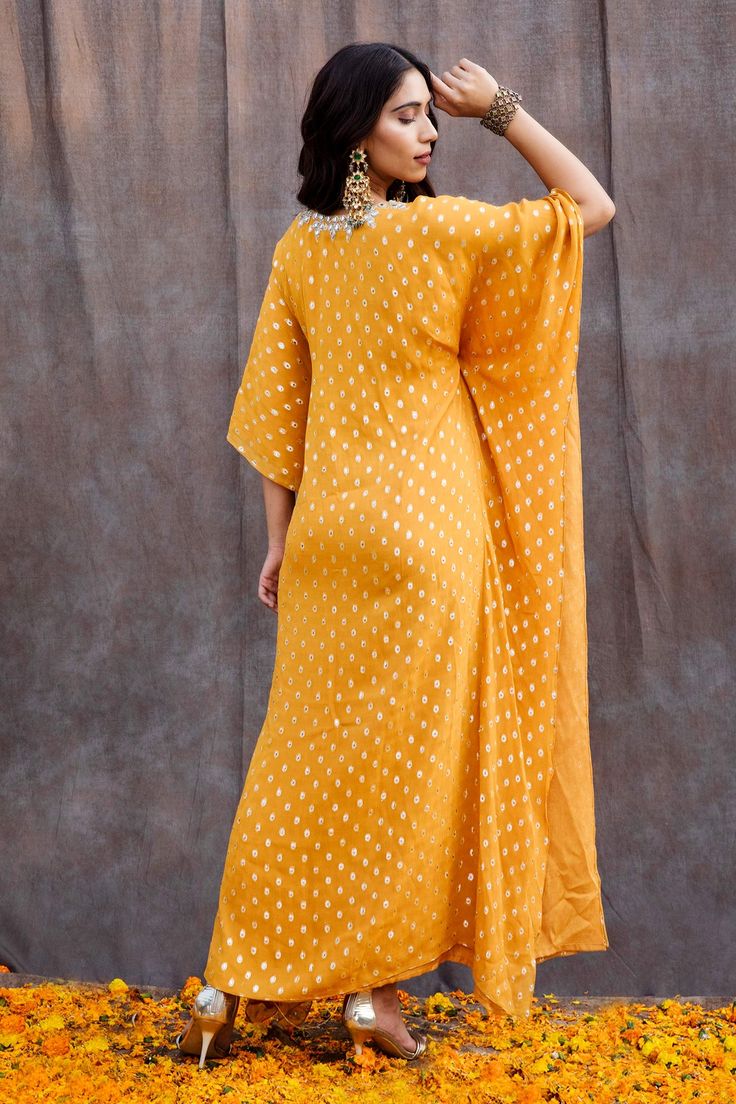 Yellow kaftan featuring mirror embellishments, side drops and front tassel tie-up.
Component: 1
Pattern: Embroidered
Type Of Work: Mirror
Neckline: V-Neck
Fabric: Georgette, Shantoon
Color: Yellow
Other Details: 
Mirror work
Side drops
Front tie-up
Floral motif tassels
Occasion: Sangeet, Mehendi and Haldi - Aza Fashions Mirror Work Kaftan, Mirror Work Embroidery, Yellow Mirror, Stylish Mirror, Yellow Mirrors, Mehndi Night, Asian Bridal, Pakistani Bridal, Fashion App