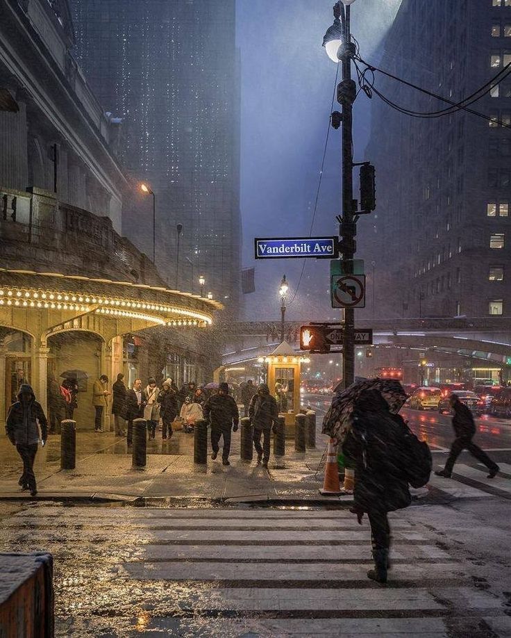 people crossing the street on a rainy day in new york city, ny at night